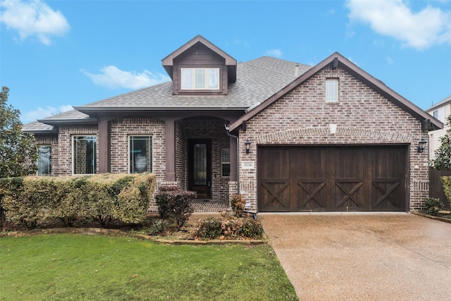 view of front of property with a garage and a front yard