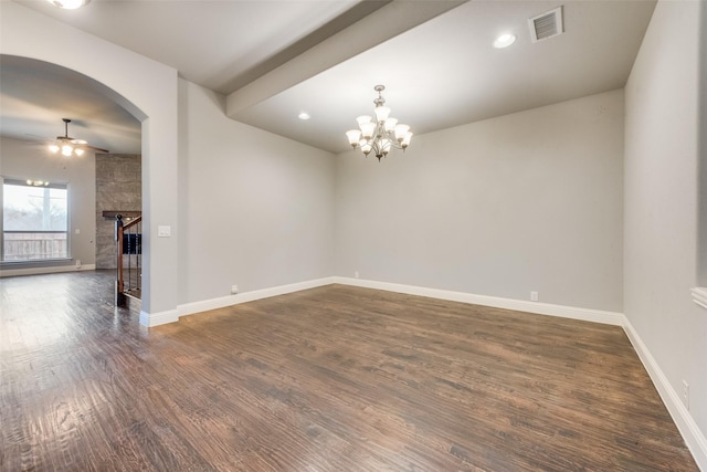 spare room featuring dark hardwood / wood-style flooring and ceiling fan with notable chandelier