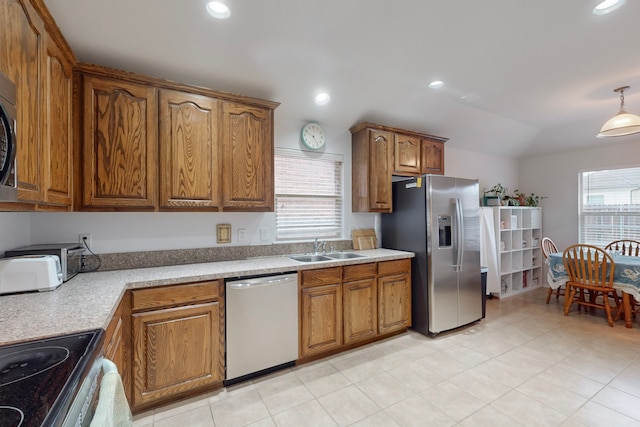 kitchen featuring pendant lighting, stainless steel appliances, sink, and plenty of natural light