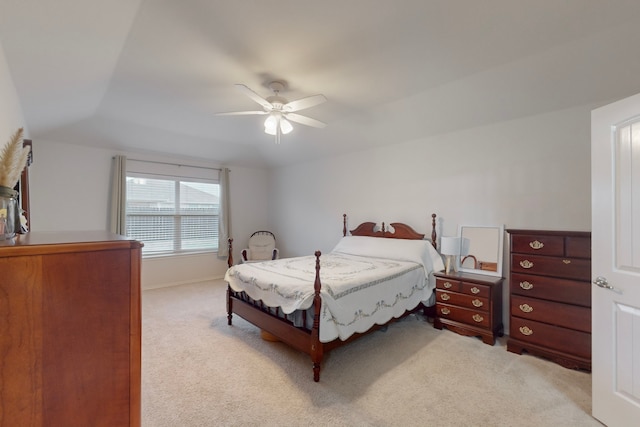 bedroom with light carpet, ceiling fan, and vaulted ceiling