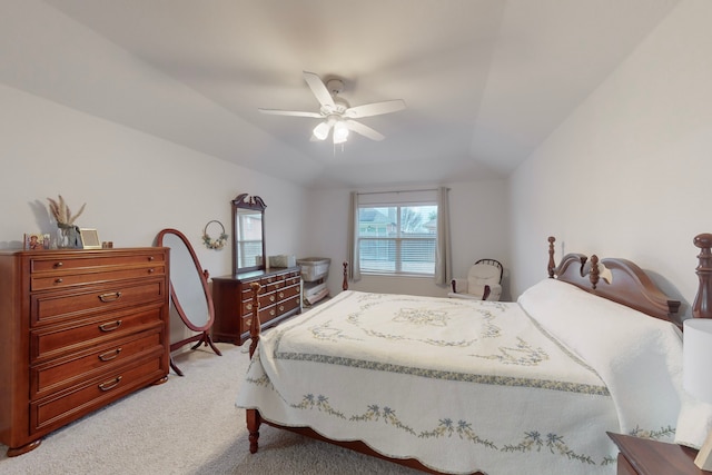 bedroom with light colored carpet, vaulted ceiling, and ceiling fan