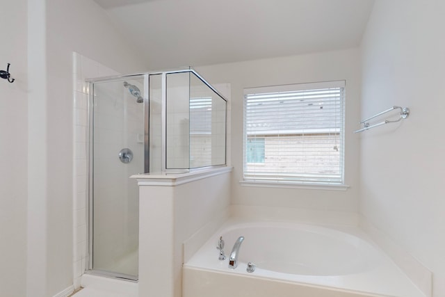 full bathroom featuring a shower stall and a bath