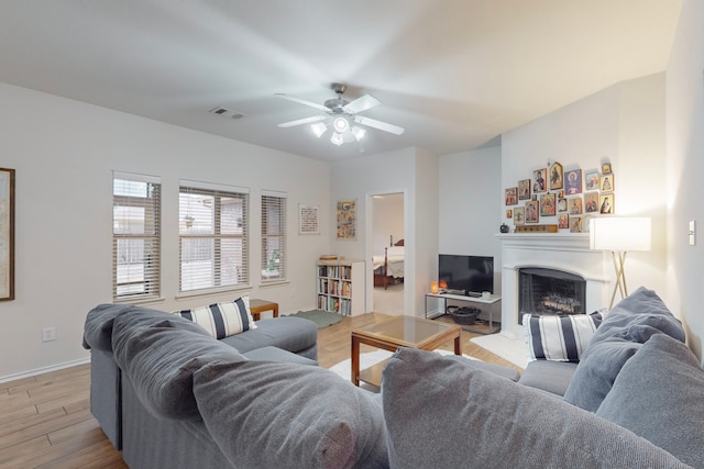 living room with ceiling fan and light wood-type flooring