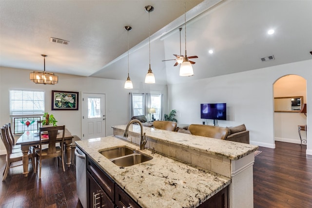 kitchen featuring sink, a kitchen island with sink, dark hardwood / wood-style floors, and decorative light fixtures