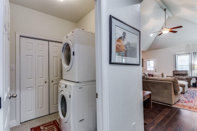 laundry area with stacked washer and dryer, wood-type flooring, and ceiling fan