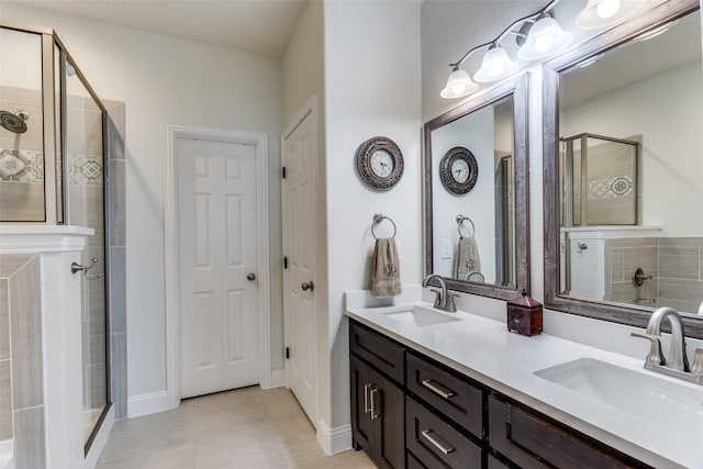 bathroom featuring vanity and a shower with shower door