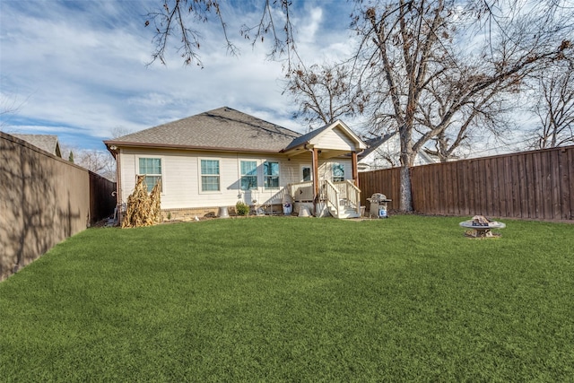 view of front of property with a front lawn and a fire pit