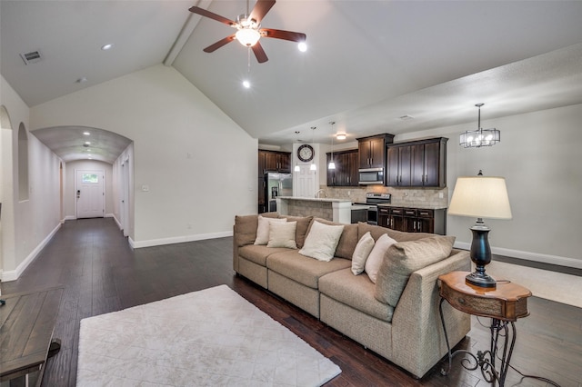 3032 James Ave, Fort Worth, TX 76110 - living room with arched walkways, a ceiling fan, dark wood-style floors, high vaulted ceiling, and recessed lighting