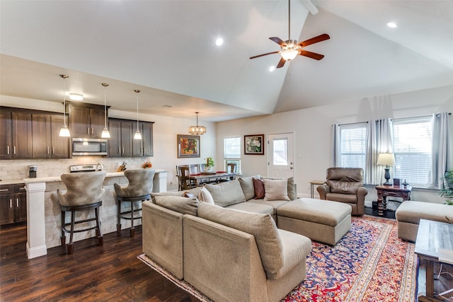 living room with high vaulted ceiling, dark hardwood / wood-style floors, and ceiling fan