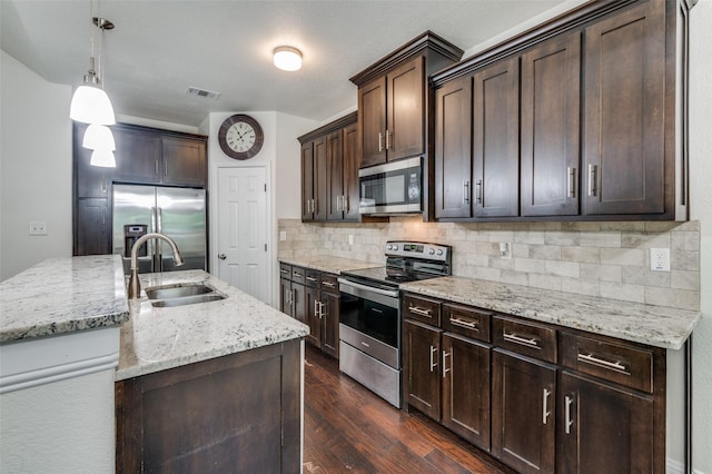 3032 James Ave, Fort Worth, TX 76110 - kitchen with stainless steel appliances, a sink, decorative backsplash, dark brown cabinets, and dark wood-style floors