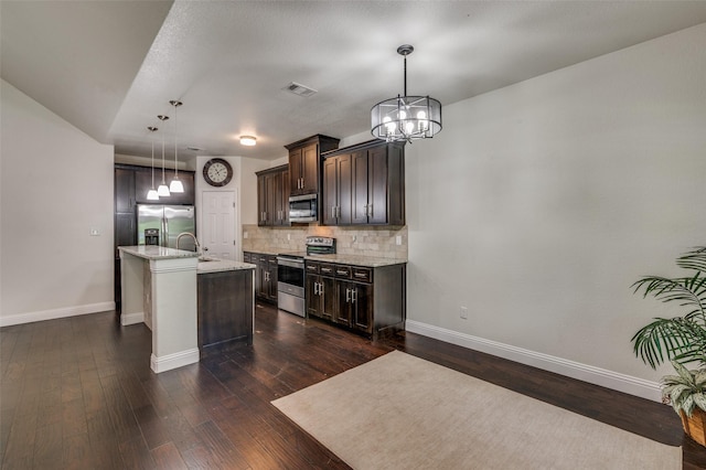 3032 James Ave, Fort Worth, TX 76110 - kitchen featuring appliances with stainless steel finishes, a chandelier, dark brown cabinets, and baseboards