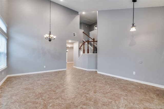 tiled empty room featuring an inviting chandelier and a towering ceiling