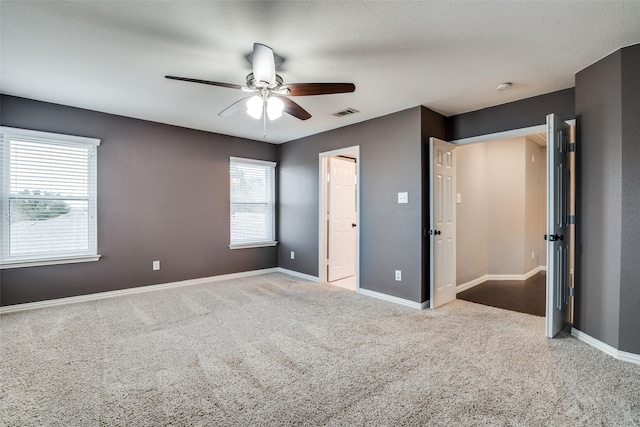 unfurnished bedroom with ceiling fan and carpet flooring