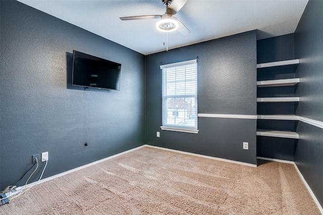 interior space with ceiling fan and carpet flooring