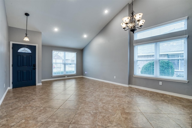 entrance foyer featuring a notable chandelier, high vaulted ceiling, and light tile patterned flooring