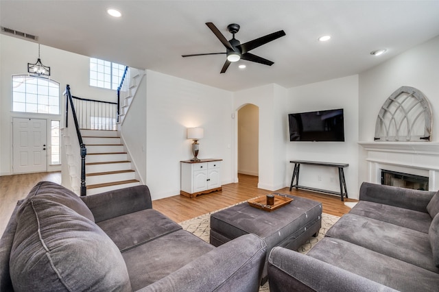 living room featuring ceiling fan and light wood-type flooring