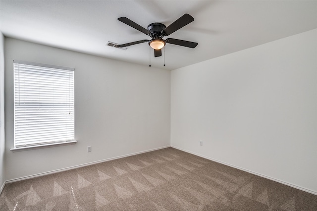 spare room with light colored carpet and ceiling fan