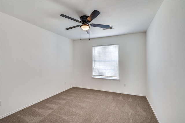 spare room featuring carpet floors and ceiling fan