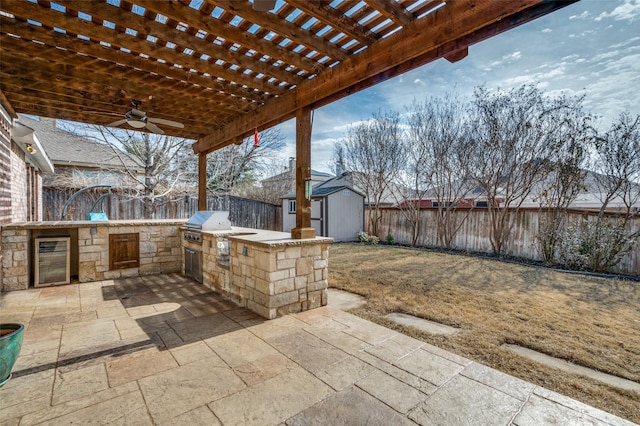 view of patio with a pergola, a grill, a storage unit, beverage cooler, and exterior kitchen