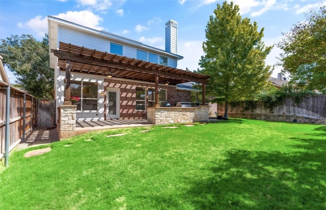 rear view of house with a pergola, a yard, and a patio