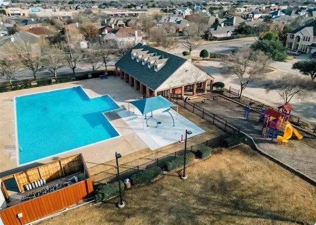 view of pool with a patio and a playground