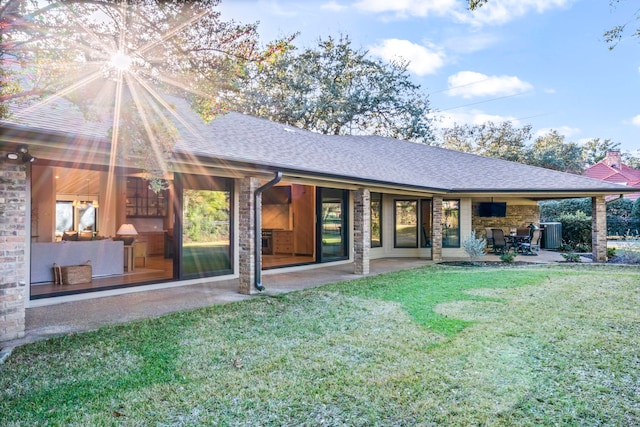 back of house featuring a patio, a yard, and central AC