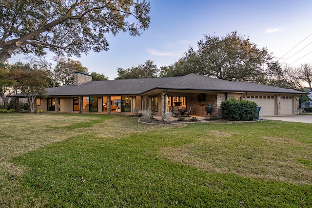 view of front facade with a garage and a front lawn