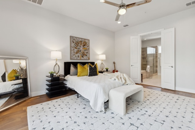 bedroom with ceiling fan, light wood-type flooring, and ensuite bath