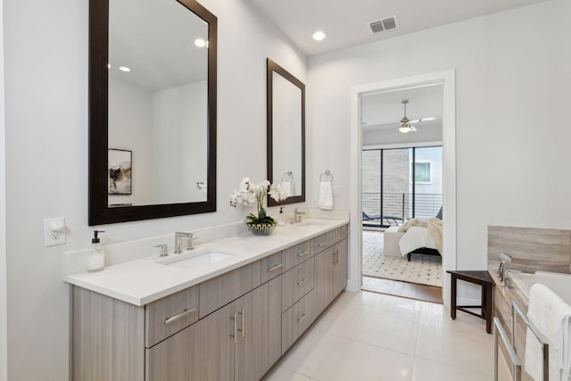 bathroom with vanity, tile patterned floors, and a bathing tub