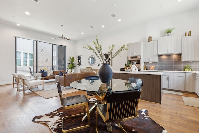 dining room featuring light hardwood / wood-style flooring and ceiling fan