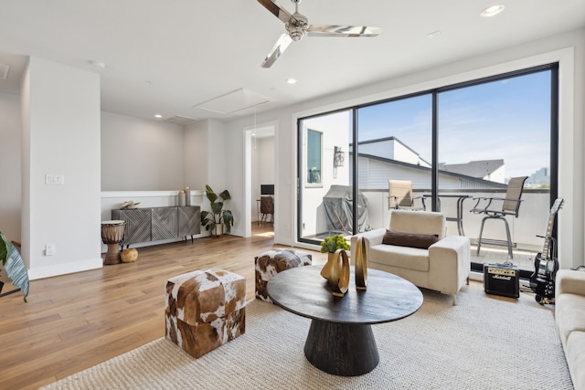 living room featuring ceiling fan and light wood-type flooring