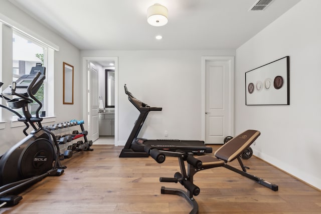 workout area featuring light wood-type flooring