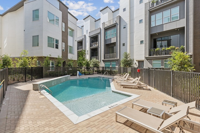 view of pool with pool water feature and a patio area