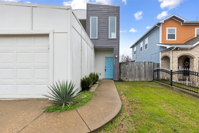 entrance to property featuring a lawn