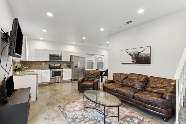 living room with sink and concrete flooring