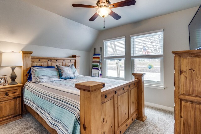 office area with a ceiling fan, lofted ceiling, light colored carpet, and baseboards