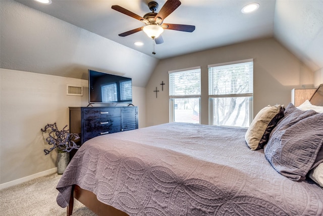 carpeted bedroom with visible vents, a ceiling fan, baseboards, and vaulted ceiling