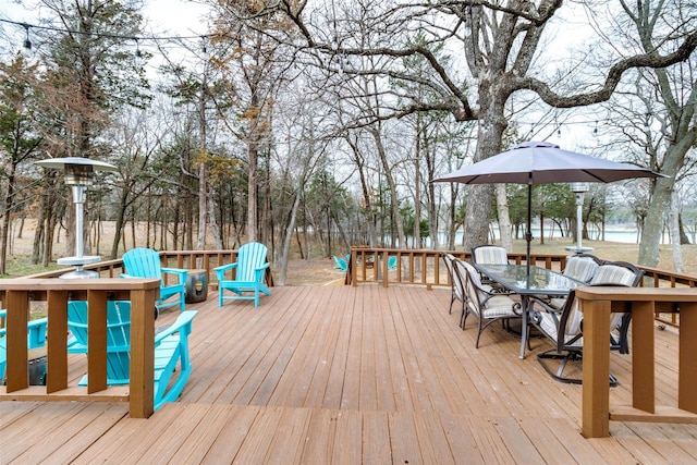 wooden terrace featuring outdoor dining area