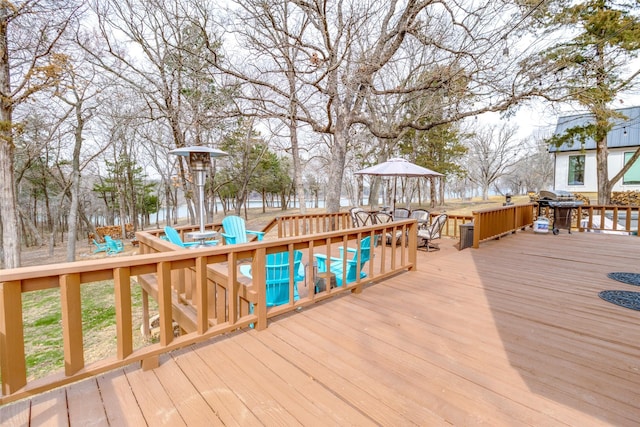wooden deck featuring a grill