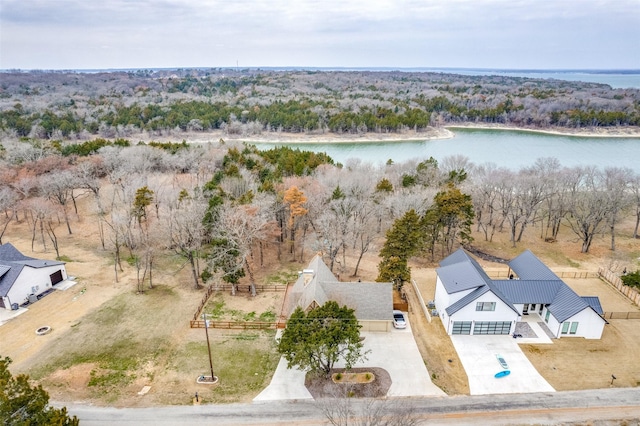 drone / aerial view with a water view and a view of trees