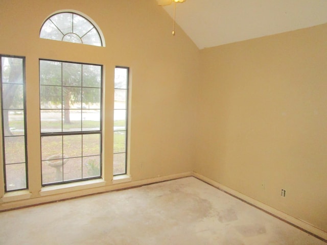 spare room with high vaulted ceiling