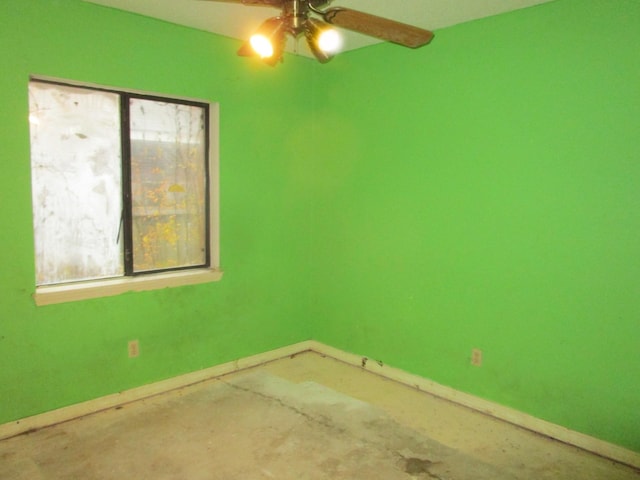 spare room with concrete flooring and ceiling fan