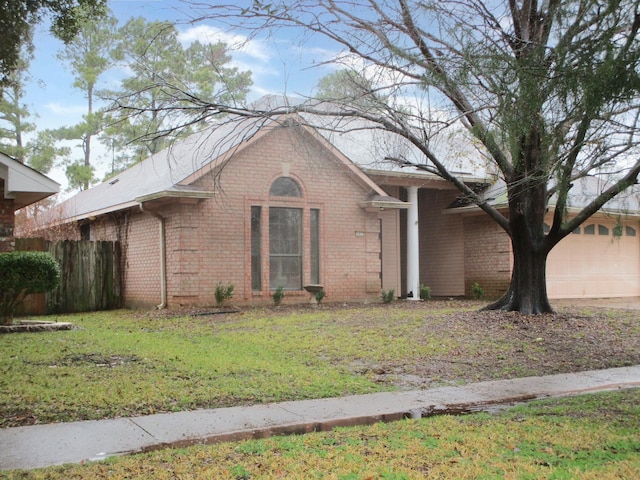 view of front of property featuring a garage and a front yard