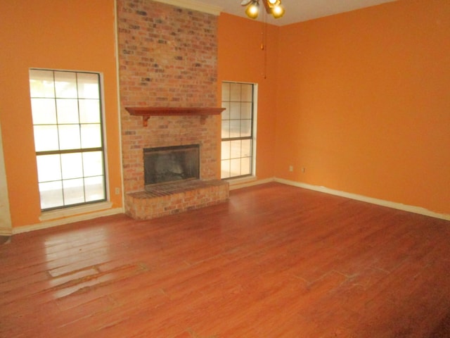 unfurnished living room featuring a fireplace and hardwood / wood-style floors