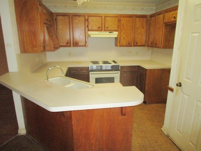 kitchen with parquet floors, kitchen peninsula, sink, and oven