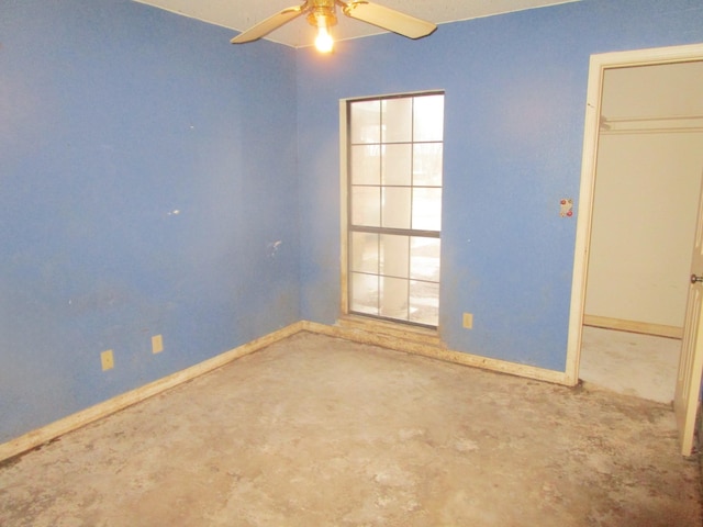 unfurnished room featuring concrete flooring and ceiling fan