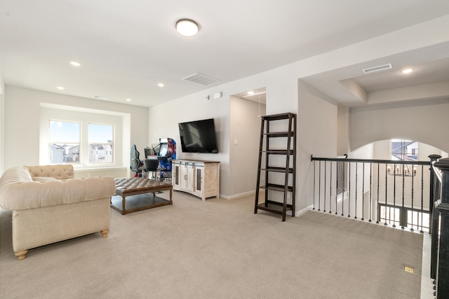 living room featuring plenty of natural light and carpet flooring