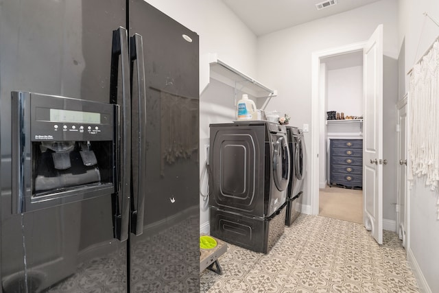 laundry room featuring washing machine and clothes dryer