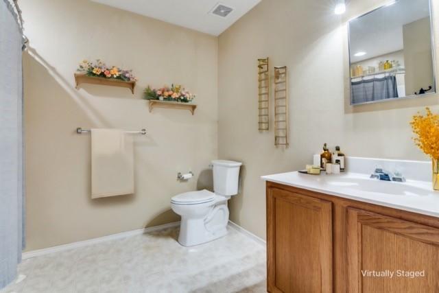 kitchen featuring sink, white cabinetry, light stone counters, black dishwasher, and pendant lighting