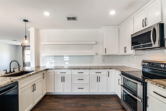 kitchen featuring pendant lighting, sink, appliances with stainless steel finishes, light stone countertops, and white cabinets